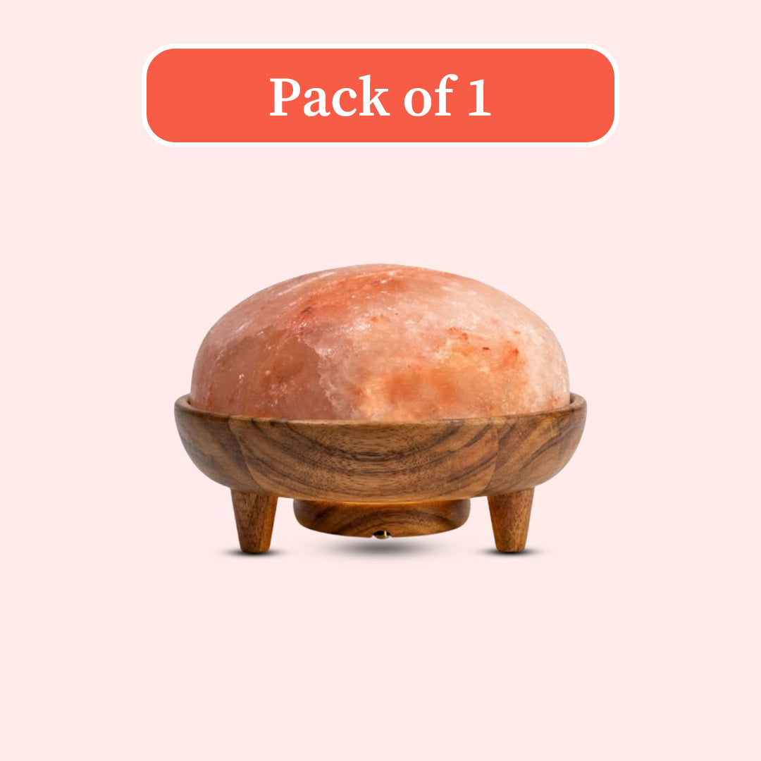 A dome-shaped pink salt stone covered in a carved wooden cap with three legs, shown on a pale pink background with a red-orange label reading 'Pack of 1' at the top.